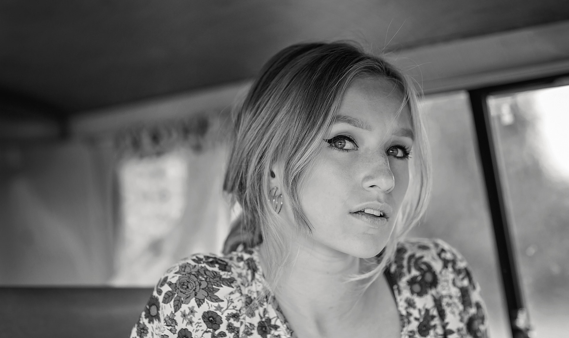 Elegant black and white portrait of a young woman with striking eyes, taken by Jo Worthington photography.