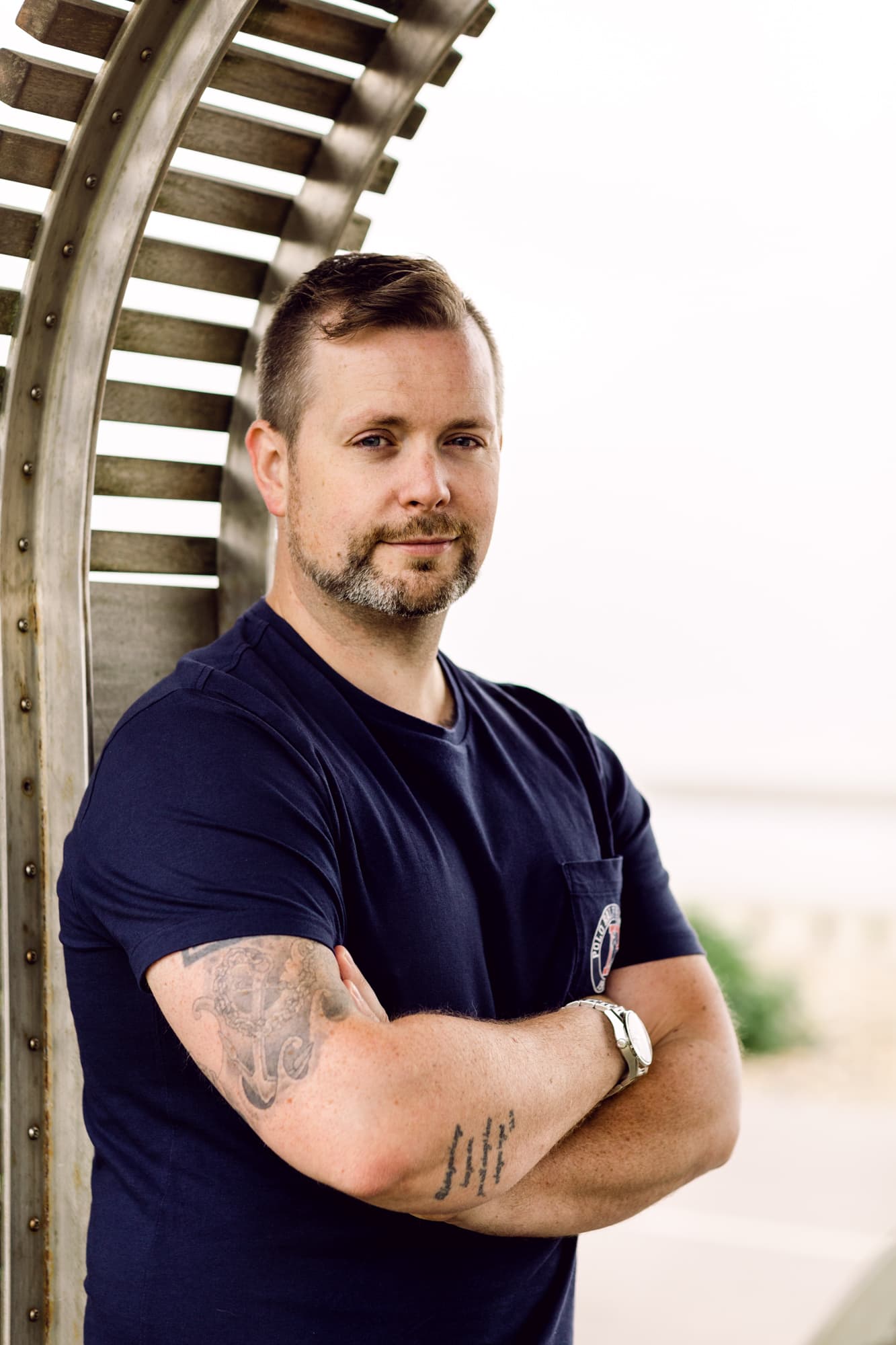 Professional portrait of a man with tattoos, outdoor photography by Jo Worthington.