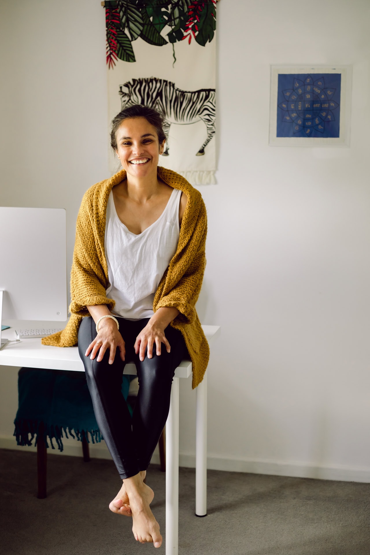 Bright smiling woman in casual studio portrait in white top and mustard cardigan at Jo Worthington Photography.