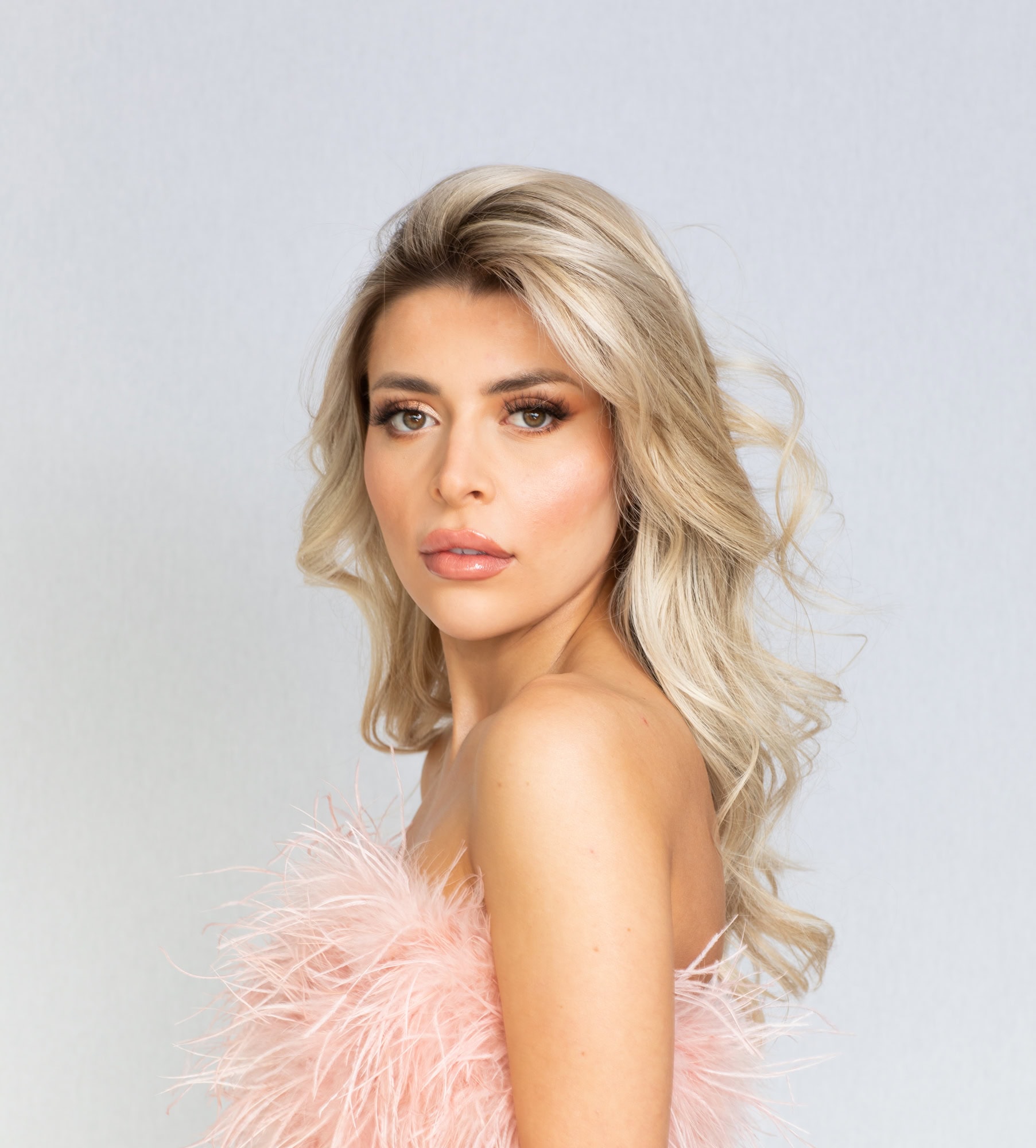 Glamorous portrait of a woman with blonde hair and flawless makeup, studio photography.