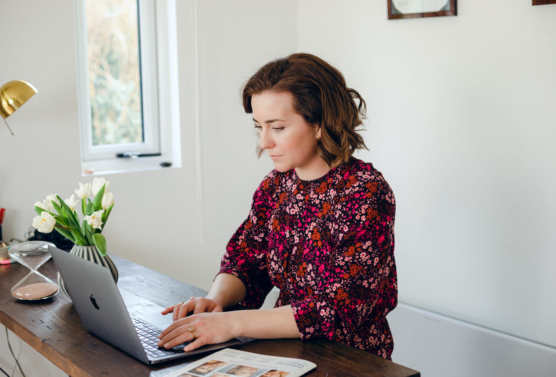 Lady at laptop in home office wearing red dress. Business Branding photography. Hampshire