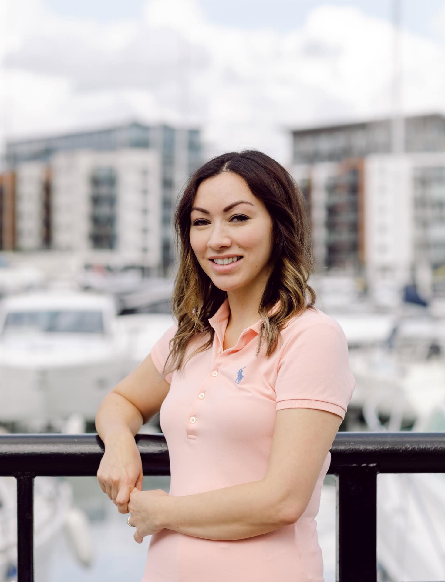Natural light portrait of woman at marina, professional photography by Jo Worthington.