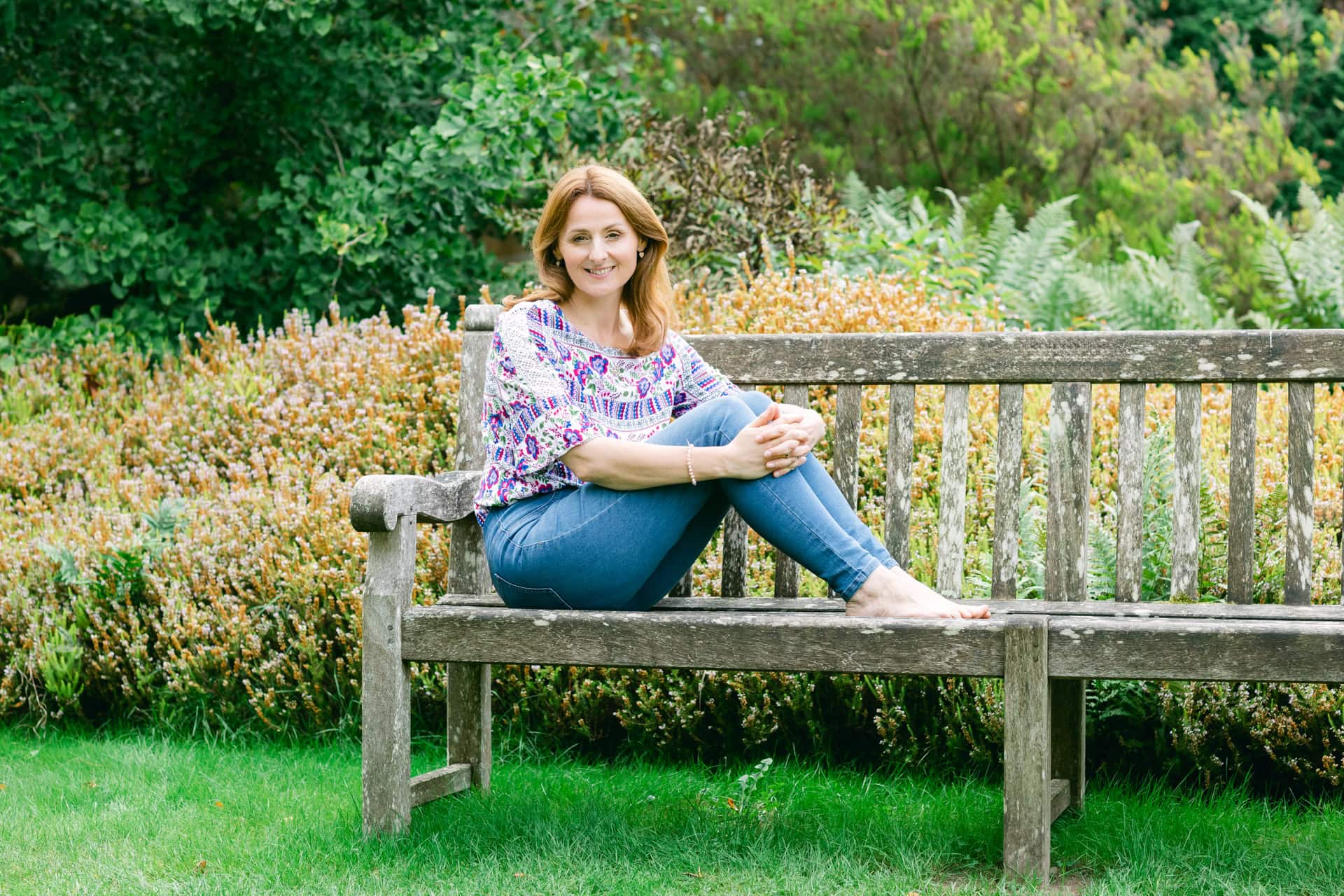 Branding photoshoots outdoors in the garden. Lady sat on the bench