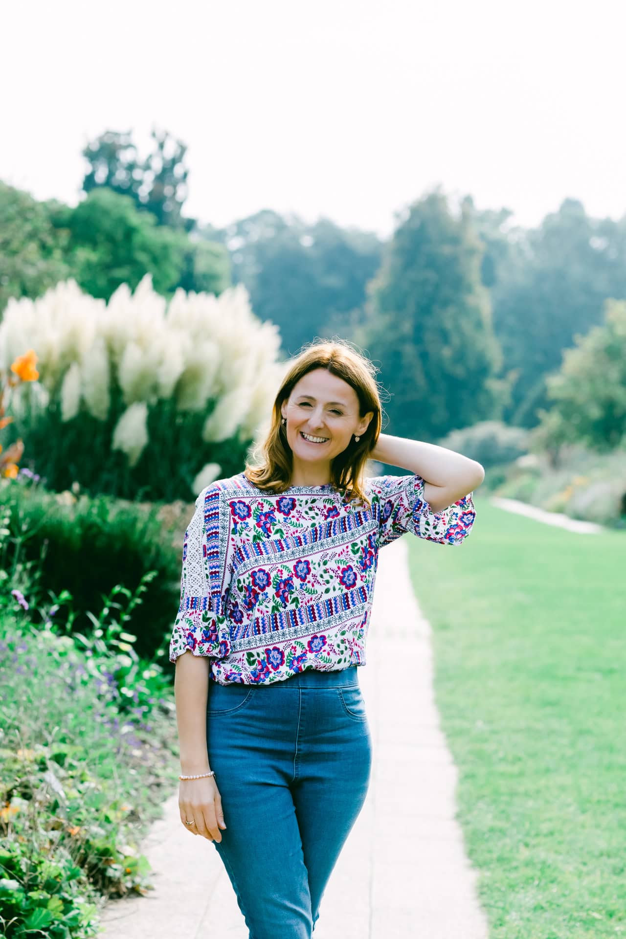 Female on branding shoot outside natural summer light in gardens