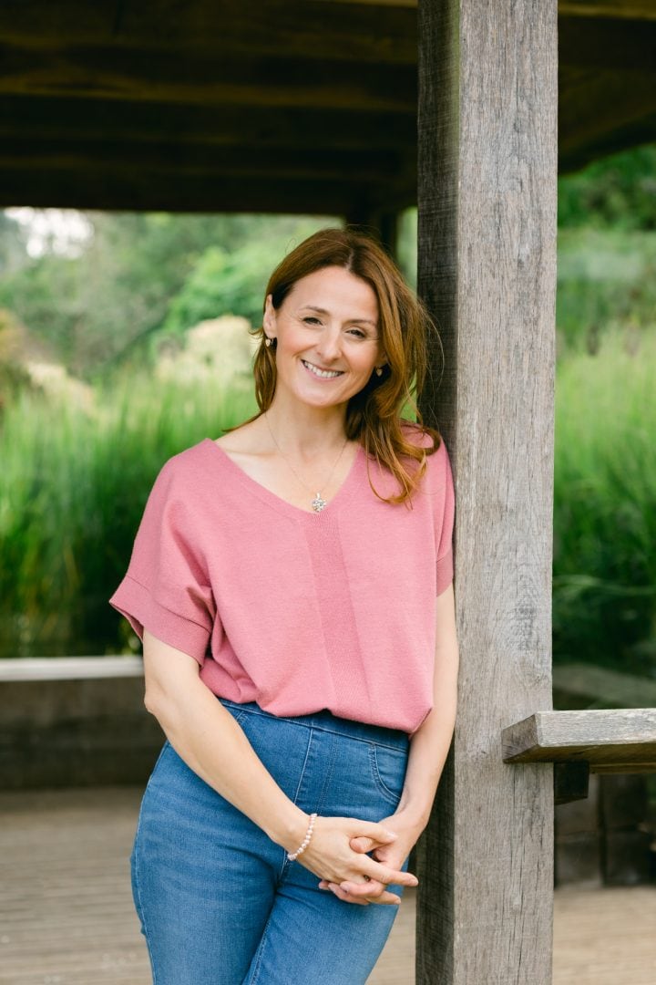 Natural portrait of a woman in an outdoor park setting, showcasing professional photography by Jo Worthington.